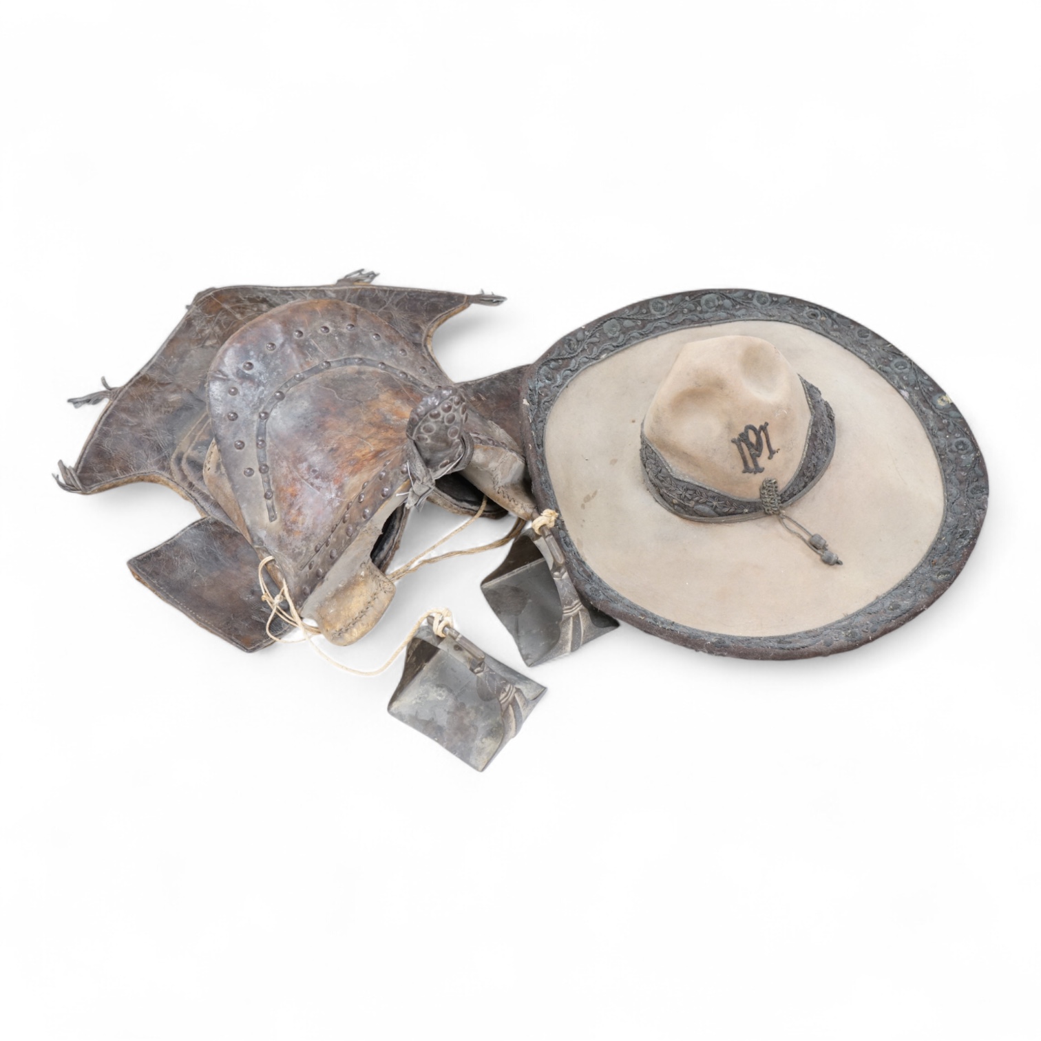 A Spanish Colonial leather saddle and a Spanish Colonial bullion work sombrero, saddle 59cm long